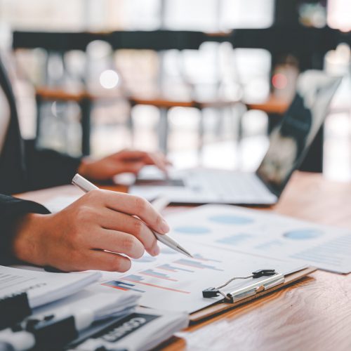 Portrait of a woman working on a tablet computer in a modern off Portrait of a woman working on a tablet computer in a modern office. Make an account analysis report. real estate investment information financial and tax system concepts